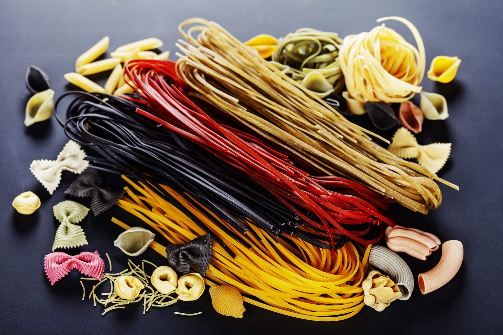 italian pasta, different varieties on dark background